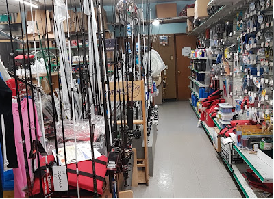 Aisle of fishing rods and reels inside the shop